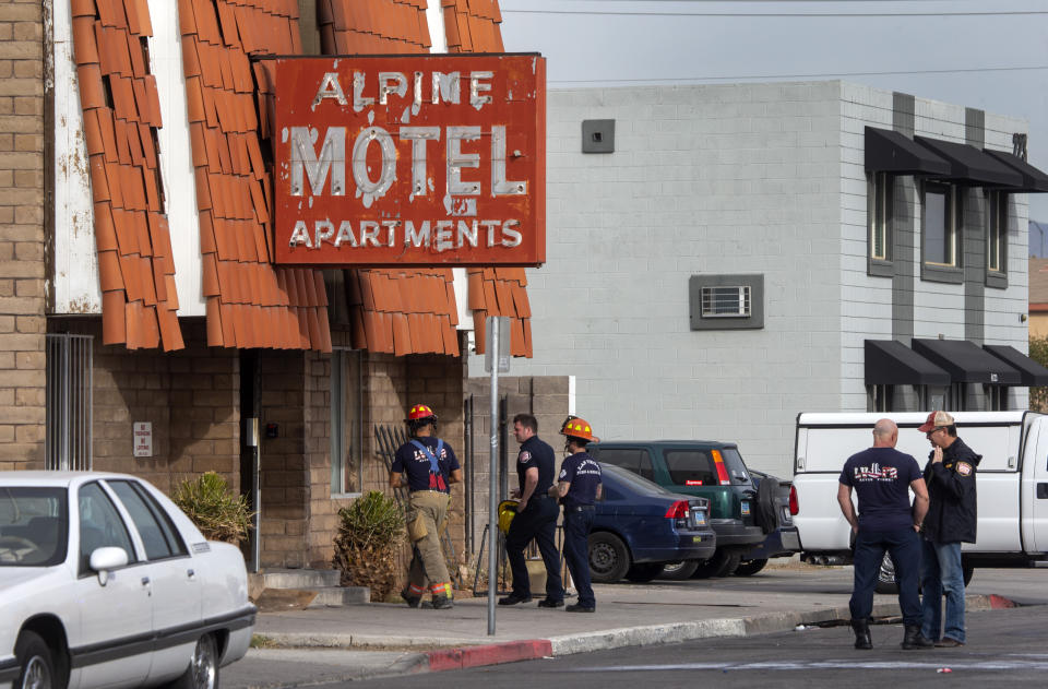 Las Vegas firefighters work the scene of a fire at a three-story apartment complex early Saturday, Dec. 21, 2019 in Las Vegas. The fire was in first-floor unit of the Alpine Motel Apartments and its cause was under investigation, the department said. Authorities say multiple fatalities were reported and several were injured. (Steve Marcus/Las Vegas Sun via AP)