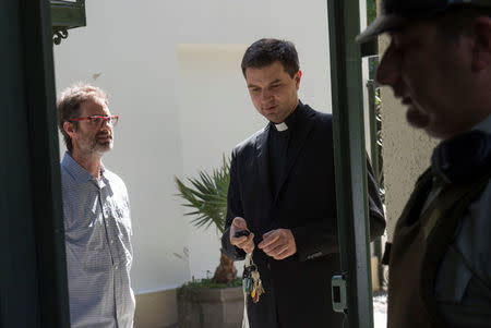 Jose Andres Murillo (L), one of the victims of sexual abuse, allegedly committed by members of the church, is seen in the exit of the Chilean apostolic nunciature after a meets with the Vatican special envoy Archbishop Charles Scicluna in Santiago, Chile February 20, 2018. REUTERS/Claudio Santana NO RESALES. NO ARCHIVE.
