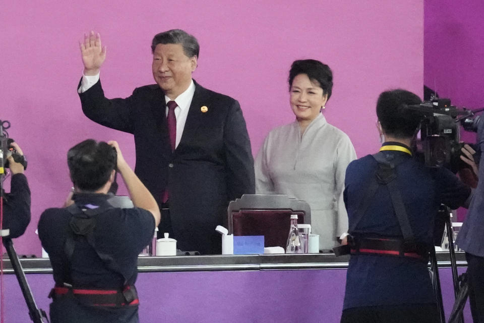 Chinese President Xi Jinping and wife Peng Liyuan arrives during the opening ceremony of the 19th Asian Games in Hangzhou, China, Saturday, Sept. 23, 2023. (AP Photo/Eugene Hoshiko)