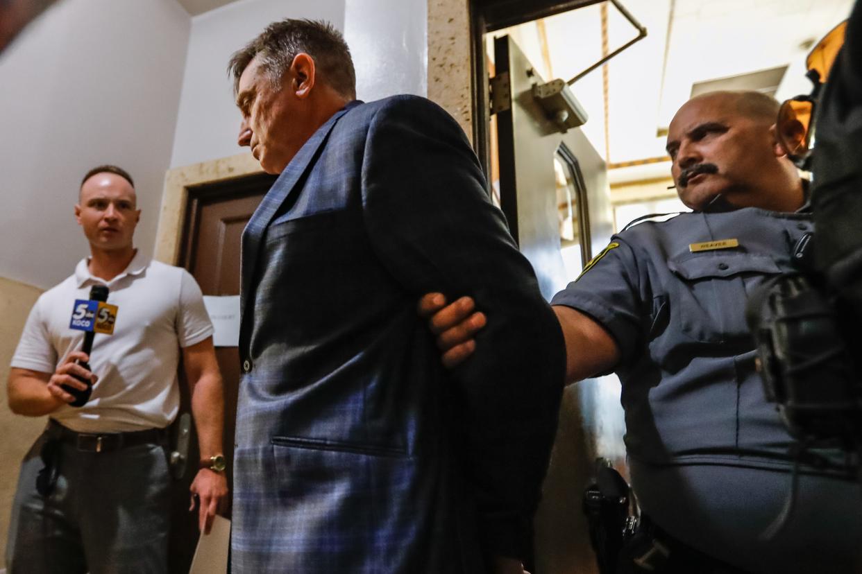 Ronald Gene Akins, former head coach at Ninnekah High School and coach at Friend Public Schools, is walked out in handcuffs Thursday at Grady County Courthouse in Chickasha.