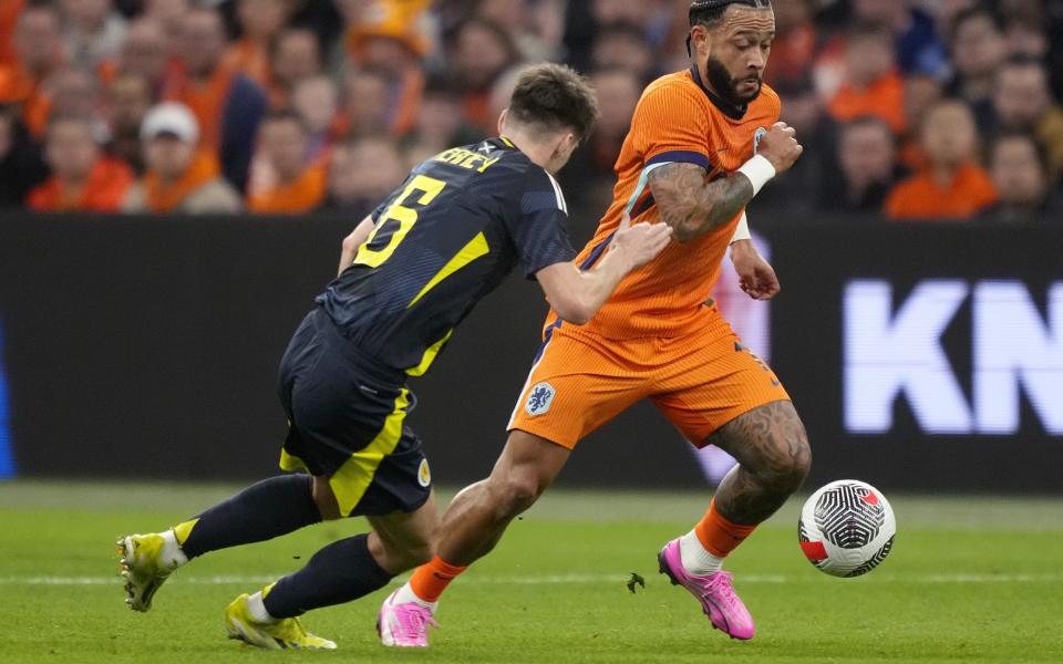 Dutch winger Memphis Depay running at Kieran Tierney