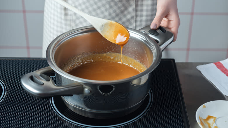 person stirring caramel