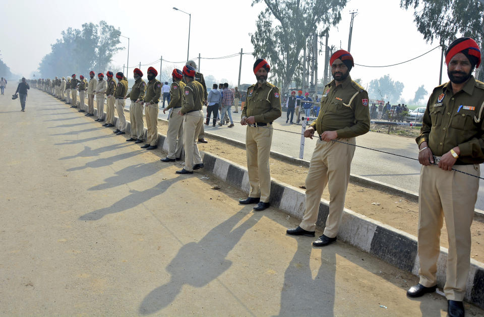 Indian policemen stand guard as they prepare to receive Indian pilot at India Pakistan border at Wagah, 28 kilometers (17.5 miles) from Amritsar, India, Friday, March 1, 2019. Pakistan is preparing to hand over a captured Indian pilot as shelling continued for a third night across the disputed Kashmir border even as the two nuclear-armed neighbors seek to defuse the most serious confrontation in two decades. (AP Photo/Prabhjot Gill)