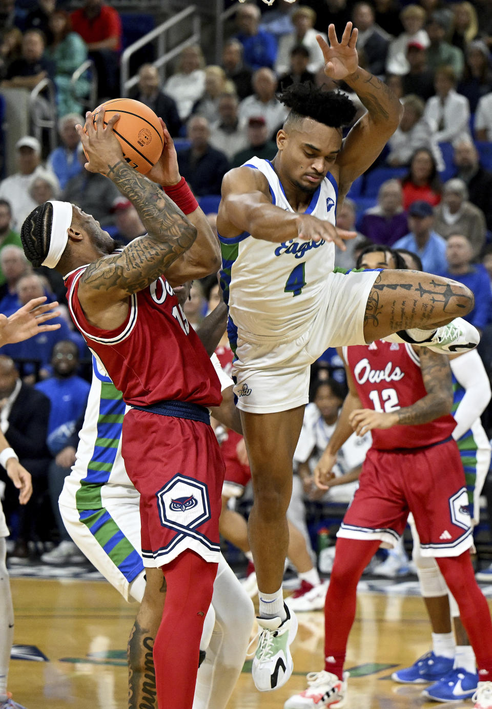 Florida Atlantic's Alijah Martinduring, left, goes up to shoot while defended by Florida Gulf Coast's Cyrus Largie (4) in the first half of an NCAA college basketball game, Saturday, Dec. 30, 2023, in Fort Myers, Fla. (AP Photo/Chris Tilley)