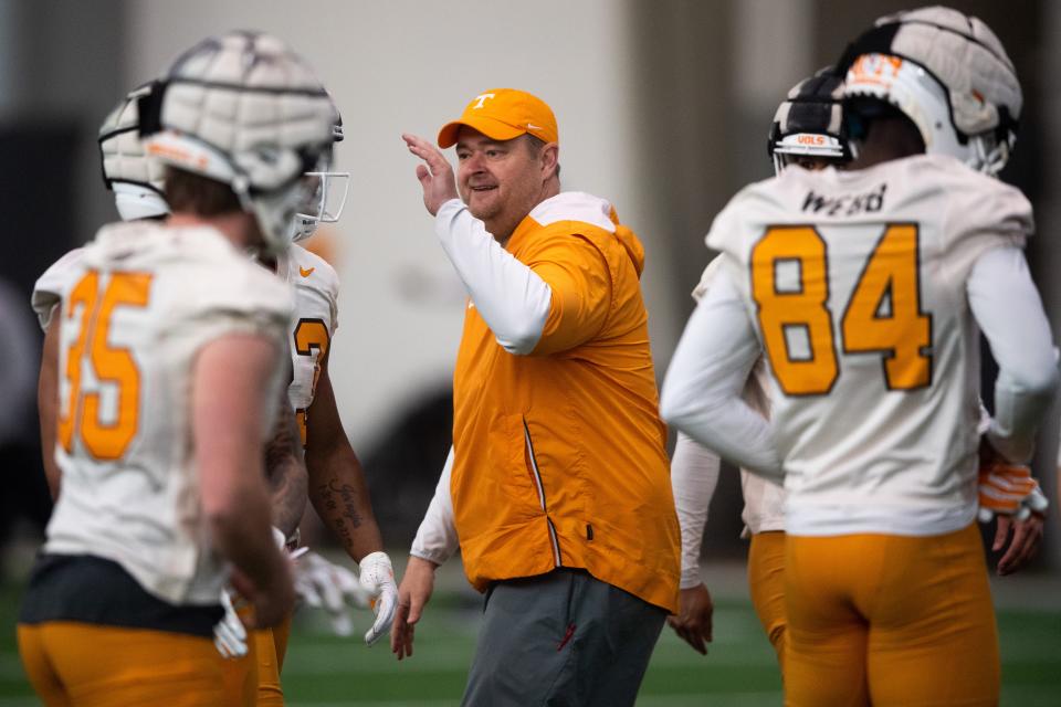 Tennessee head coach Josh Heupel, center, high fives his players during spring football practice on Monday, March 20, 2023.