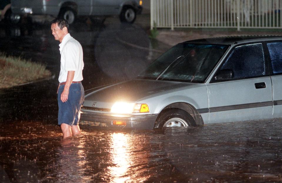 1998: A motorist's car is stuck in rain water on Hatcher Road near 13th Street during a monsoon storm in Phoenix. The National Weather Service issued an urban and small stream flood advisory at about 8:30 p.m. for the Phoenix area that was to last until midnight.