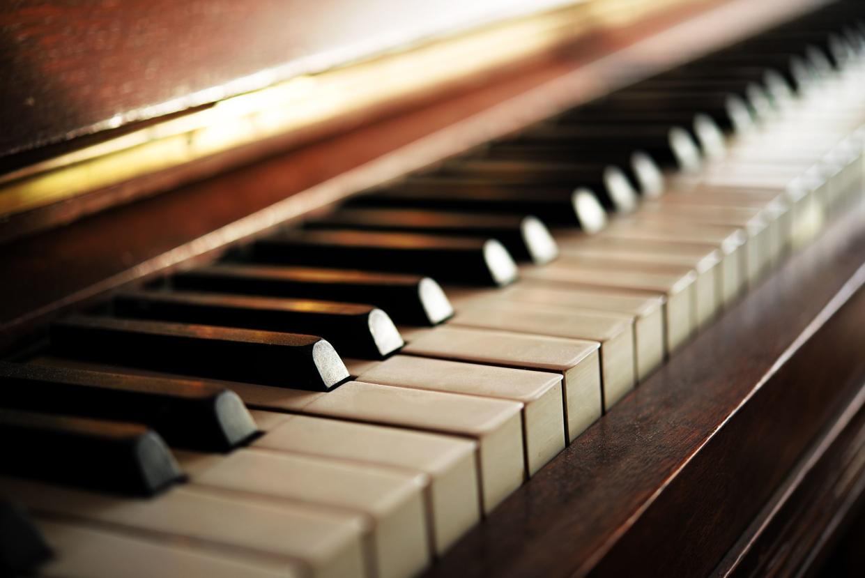Piano keyboard of an old music instrument, close up with blurry background, selective focus and very narrow depth of field