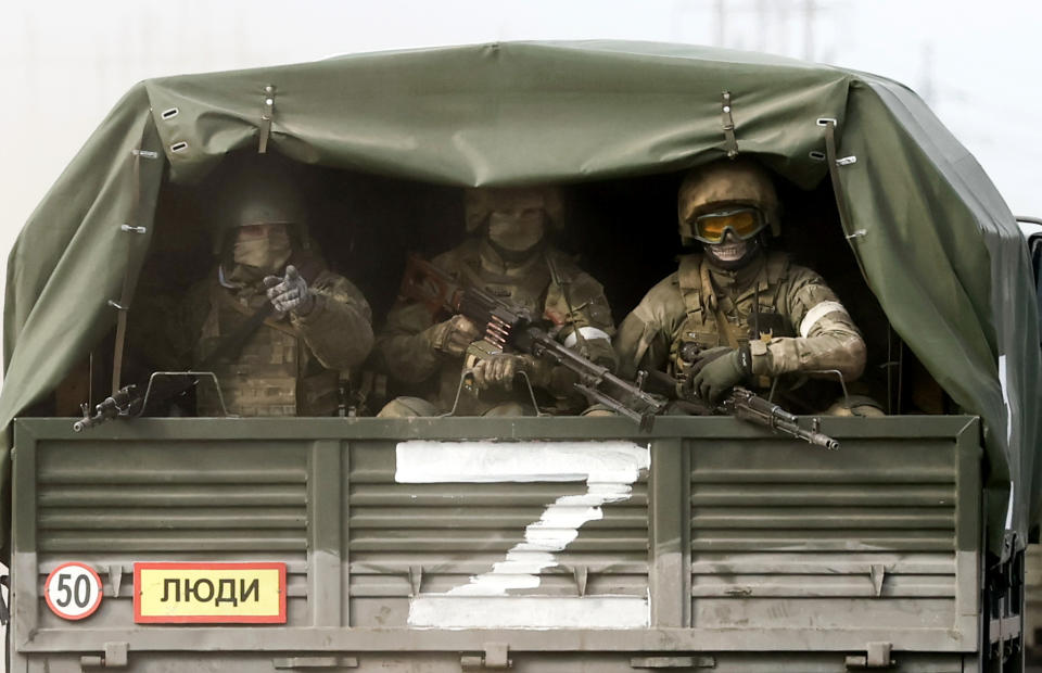 CRIMEA, RUSSIA - FEBRUARY 24, 2022: Servicemen ride on a truck to the Perekop checkpoint on the Ukrainian border. Early on February 24, President Putin announced a special military operation to be conducted by the Russian Armed Forces in response to appeals for help from the leaders of the Donetsk and Lugansk People's Republics. Sergei Malgavko/TASS (Photo by Sergei Malgavko\TASS via Getty Images)