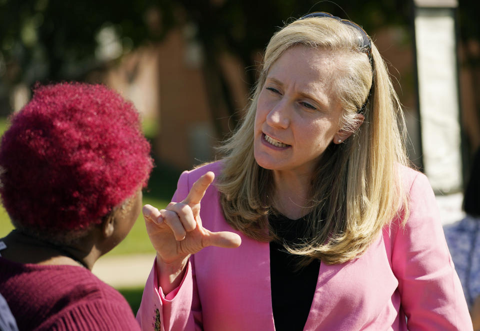 FILE - U.S. Rep Abigail Spanberger, D-Va., right, talks with a supporter at an early voting location, Tuesday, Oct. 11, 2022, in Stafford, Va. The race for Virginia's 7th Congressional District is a nail-biter in the final stretch and a contest that could help determine which party controls the U.S. House. (AP Photo/Steve Helber, File)