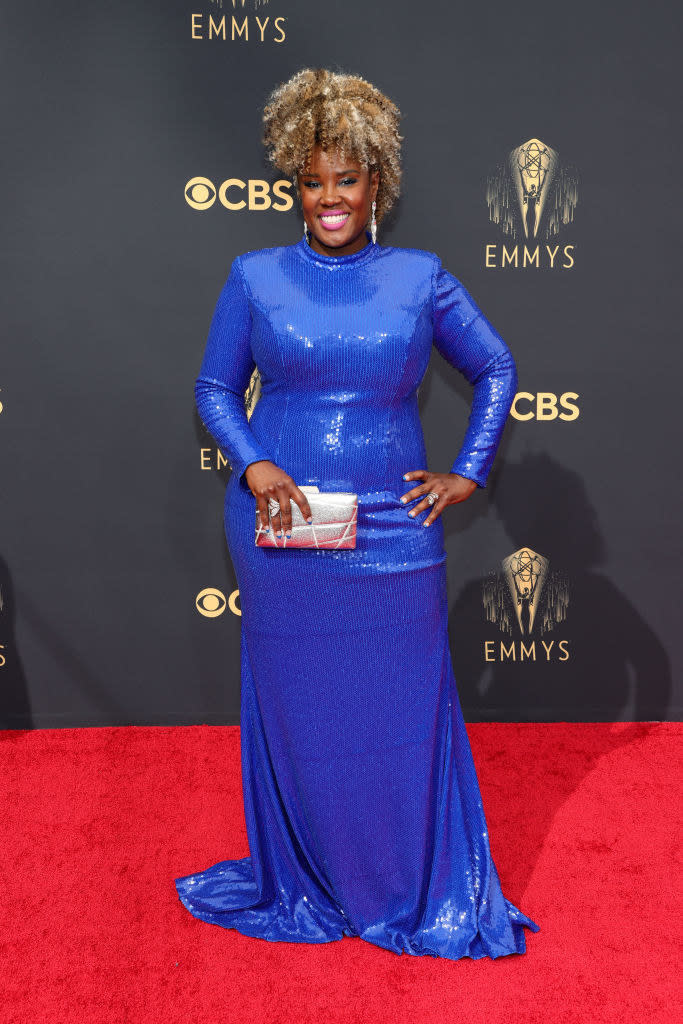 Akilah Green on the red carpet in a high neck blue sequin gown