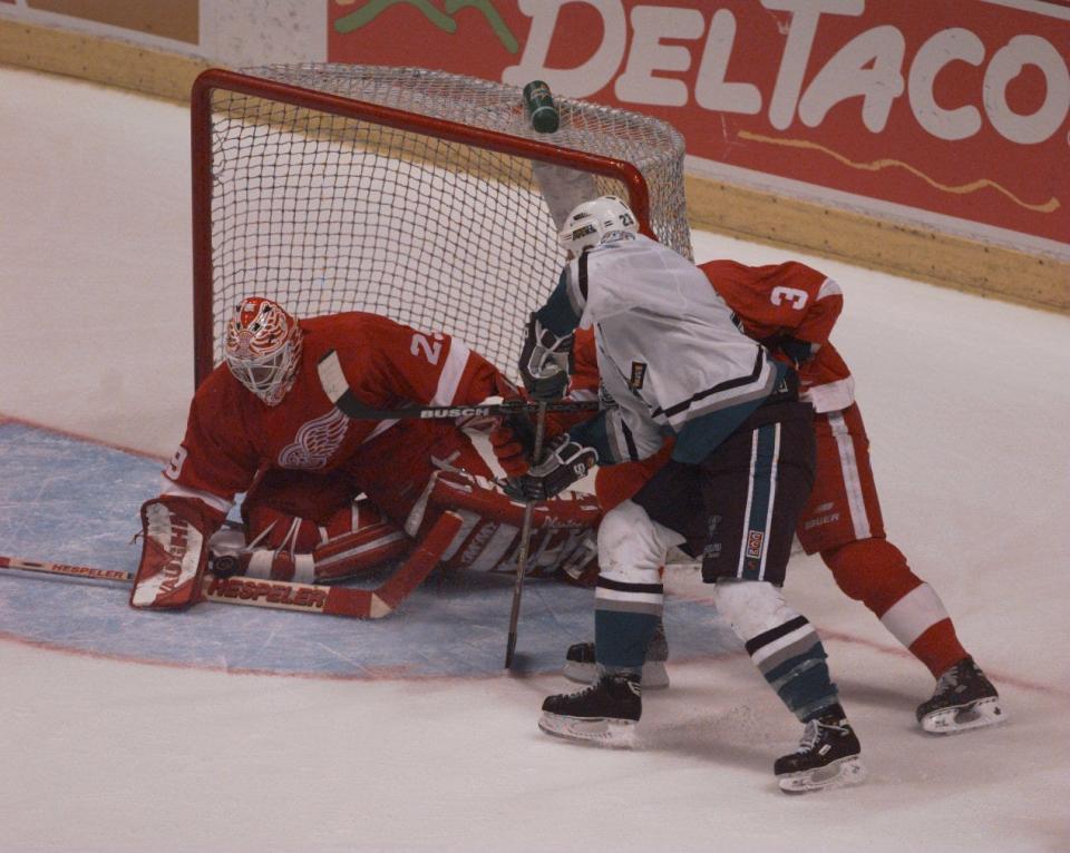 Anaheim Mighty Ducks' Brian Bellows works near the goal during the second overtime, as Detroit Red Wings goalie Mike Vernon makes a stop on the puck and Bob Rouse defends in Anaheim, Calif., May 8, 1997.