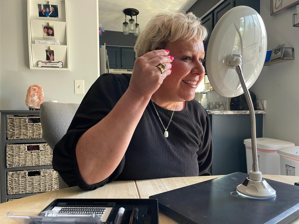 Beth Williams demonstrates to how to apply her line of Dolce Catalina eyelashes at her Brighton home on Wednesday, May 15.