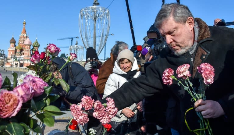 Russian presidential candidate Grigory Yavlinsky lays flowers earlier this year in Moscow at the spot where opposition leader Boris Nemtsov was fatally shot