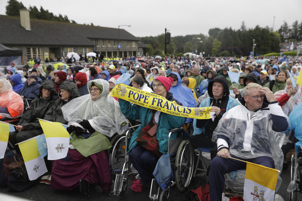 People wait for the arrival of Pope Francis at the Knock Shrine, in Knock, Ireland, Sunday, Aug. 26, 2018. (AP Photo/Gregorio Borgia)