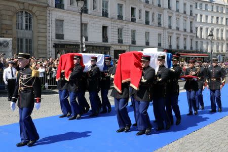 The flag-draped coffins of late Auschwitz survivor and French health minister Simone Veil and her late husband Antoine Veil are carried by members of the French Gardes Republicains during a national tribute before being laid to rest in the crypt of the Pantheon mausoleum, in Paris, France, July 1, 2018. Ludovic Marin/Pool via Reuters