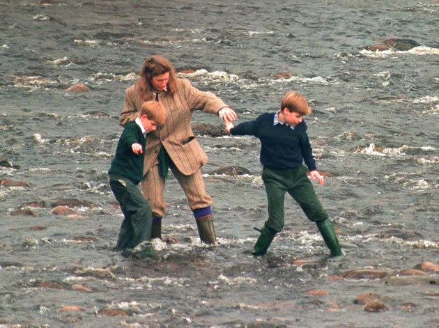 Pettifer leads Prince Harry (left) and Prince William (right) across the River Gairn, near the royal Balmoral Estate, on October 22, 1994. (Photo: Julian Parker via Getty Images)