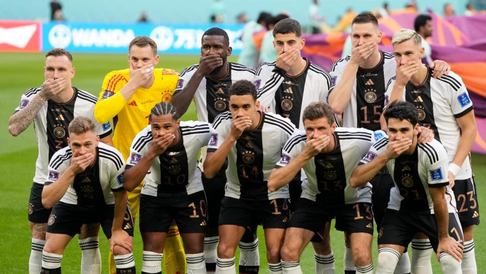 German's team covers their mouth during the team photo prior to the World Cup group E football match between Germany and Japan, at the Khalifa International Stadium in Doha, Qatar, Wednesday, Nov. 23, 2022. (AP Photo/Matthias Schrader)