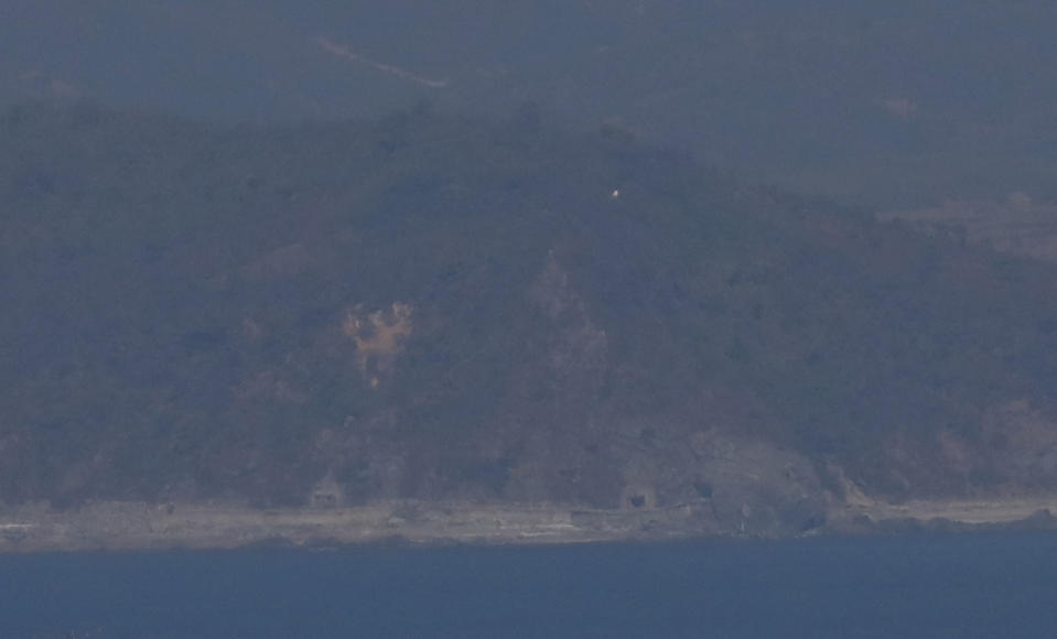 North Korea's Gaemeori western coastal artillery positions in the Hwanghae Province are seen from South Korea's western island of Yeonpyeong, South Korea, Thursday, Nov. 1, 2018. The U.S. and South Korea are reviewing whether they will conduct large-scale military exercises next year and will decide before December. South Korean Defense Minister Jeong Kyeong-doo told reporters Wednesday at the Pentagon that if more exercises are suspended the two countries will conduct other training to mitigate the lapse. He says the review will be done by Nov. 15. (Jeon Heon-kyun/Pool Photo via AP)