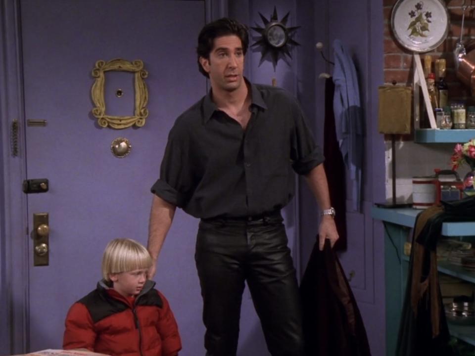 ross geller in leather pants and a loose fitting short sleeve button down