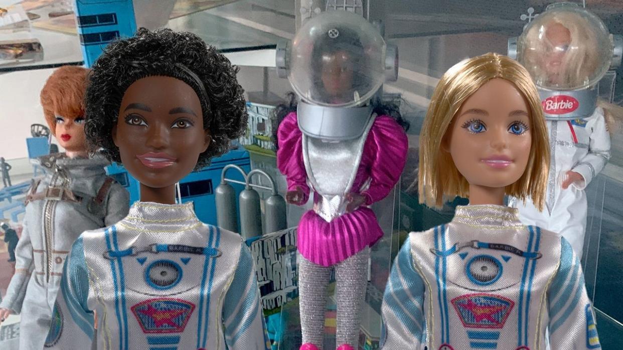  three barbie dolls in space suits 