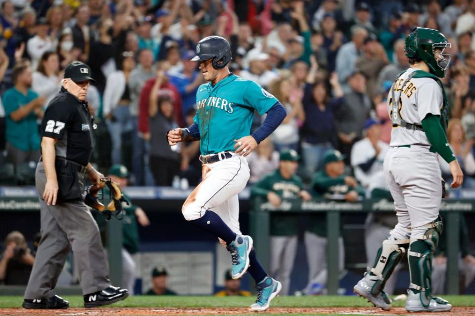 SEATTLE, WASHINGTON - SEPTEMBER 30: Dylan Moore #25 of the Seattle Mariners scores a run during the first inning against the Oakland Athletics at T-Mobile Park on September 30, 2022 in Seattle, Washington. (Photo by Steph Chambers/Getty Images)