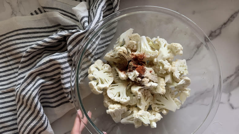 cauliflower in bowl with seasonings