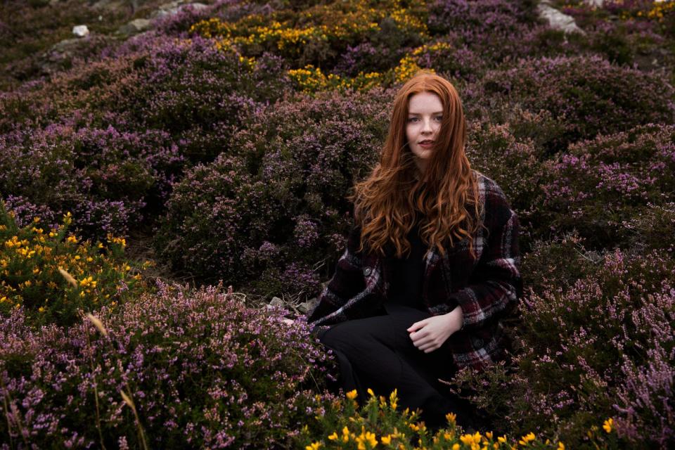 A redheaded model named Grace from Malahide, Ireland photographed in a field