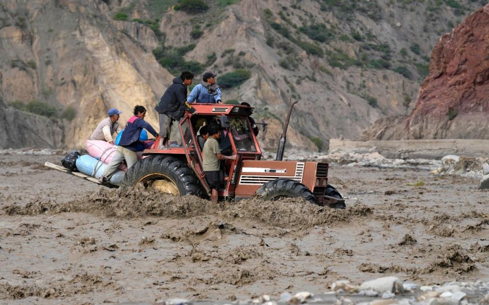 Farmers transport their produce through a mudslide in El Penol, Bolivia