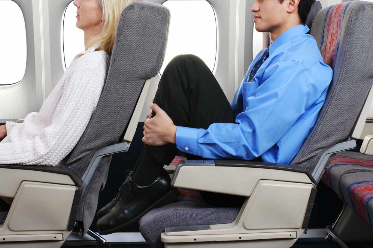 <p>Getty</p> Airline passenger reclining their seat back onto the person behind them