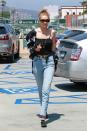 <p>In RE/DONE high-waisted jeans, a blouse as a jacket, Andre Assous shoes and RAEN retro shades while out in Beverly Hills. </p>