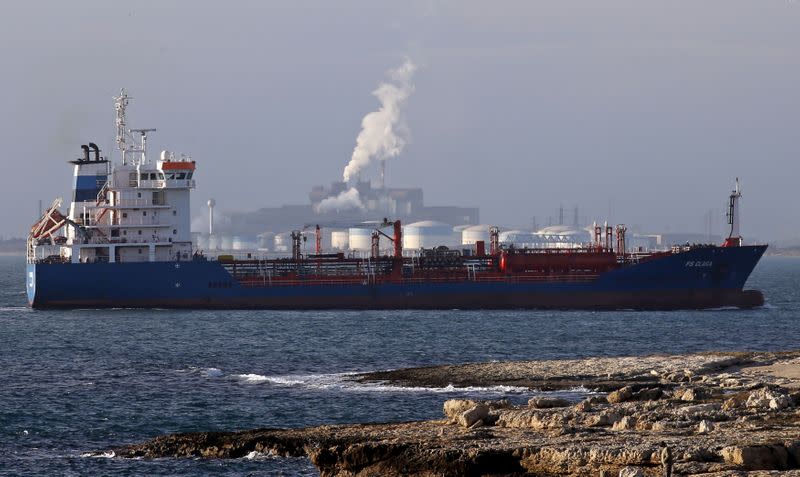 FILE PHOTO: An oiil tanker sits anchored off DPF oil refinery and the ArcelorMittal's steel plant on the site of Fos-sur-Mer near Marseille