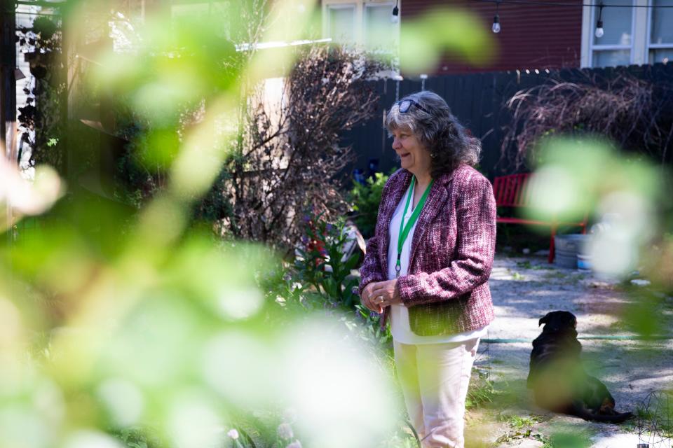 Sharron Johnson, the co-chair of the Cooper-Young Garden Club, laughs while speaking with Kim Halyak in Halyak’s backyard garden in Memphis, Tenn., on May 2, 2023. Halyak’s garden will be featured in the “Experience Memphis Gardens” event that they both helped organize. 