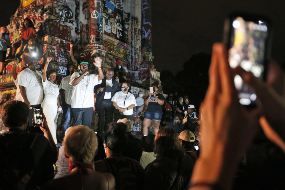 CORRECTS SPELLING OF FIRST NAME TO PHILONISE FROM FELONIOUS - Philonise Floyd, brother George Floyd, gestures as he addresses a crowd in front of the statue of Confederate General Robert E. Lee on Monument Avenue Tuesday July 28, 2020, in Richmond, Va. Change.org and the George Floyd foundation officially launched "A Monumental Change: The George Floyd Hologram Memorial Project" in Richmond, the capital of the Confederacy (AP Photo/Steve Helber)