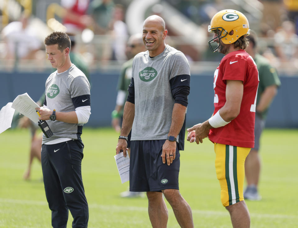 Green Bay Packers quarterback Aaron Rodgers and New York Jets head coach Robert Saleh and offensive coordinator Mike LaFleur (left) share a laugh during a joint NFL football training camp practice Wednesday, Aug. 18, 2021, in Green Bay, Wis. (AP Photo/Matt Ludtke)