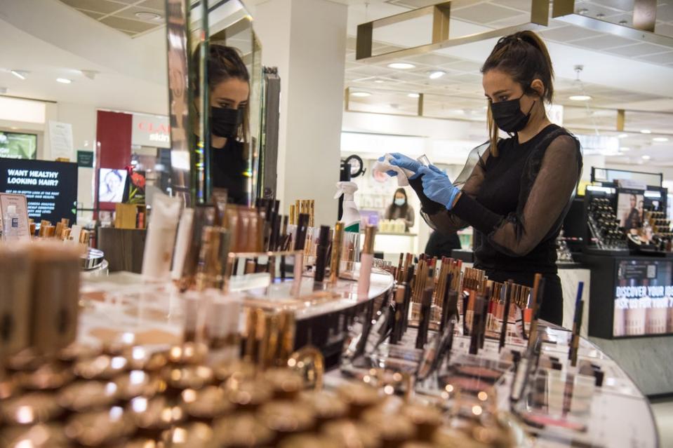 A John Lewis partner cleans a counter (Kirsty O’Connor/PA) (PA Wire)