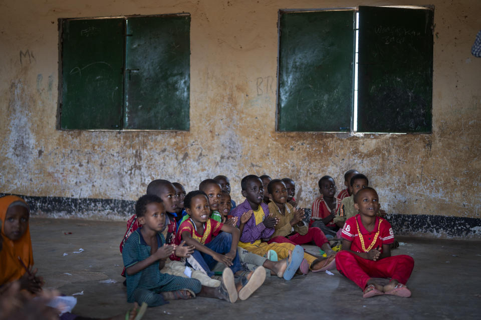 Children attend a class in a school in Dollow, Somalia, on Monday, Sept. 19, 2022. At midday, dozens of hungry children from the camps try to slip into a local primary school where the World Food Program offers a rare lunch program for students. (AP Photo/Jerome Delay)
