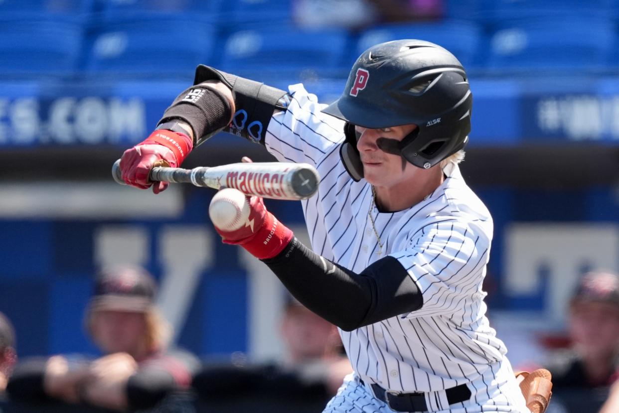 Pleasure Ridge Park's Brayden Bruner (14) bunts during their game against McCracken County on Saturday, June 15, 2024 in Lexington, Ky. at Kentucky Proud Park for the state baseball championship.