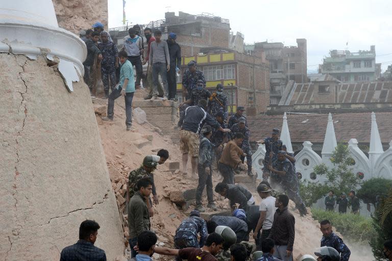 Nepalese rescue members gather at the collapsed Dharahara Tower in Kathmandu, on April 25, 2015
