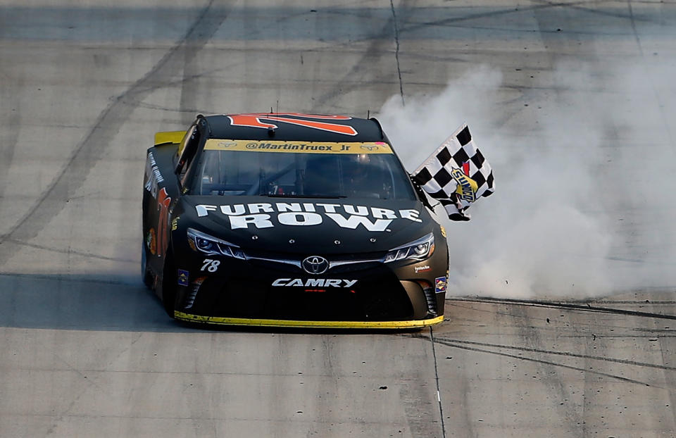 DOVER, DE - OCTOBER 02: Martin Truex Jr., driver of the #78 Furniture Row/Denver Mattress Toyota, celebrates with the checkered flag after winning the NASCAR Sprint Cup Series Citizen Solider 400 at Dover International Speedway on October 2, 2016 in Dover, Delaware. (Photo by Brian Lawdermilk/Getty Images)