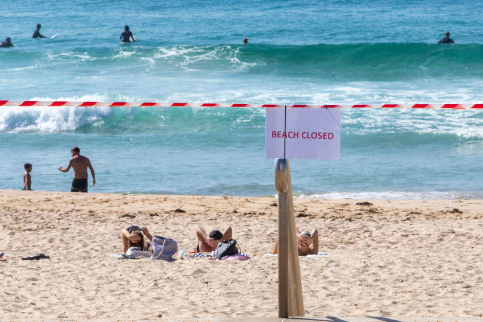 Pictured is a 'beach closed' sign at Maroubra Beach in Sydney's east, shut down due to coronavirus.