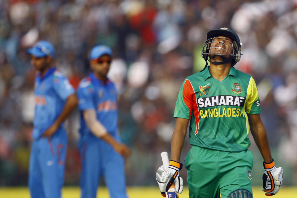 Bangladesh’s Anamul Haque, right, reacts as he walks back to the pavilion after his dismissal by India’s Varun Aaron during the Asia Cup one-day international cricket tournament in Fatullah, near Dhaka, Bangladesh, Wednesday, Feb. 26, 2014. (AP Photo/A.M. Ahad)