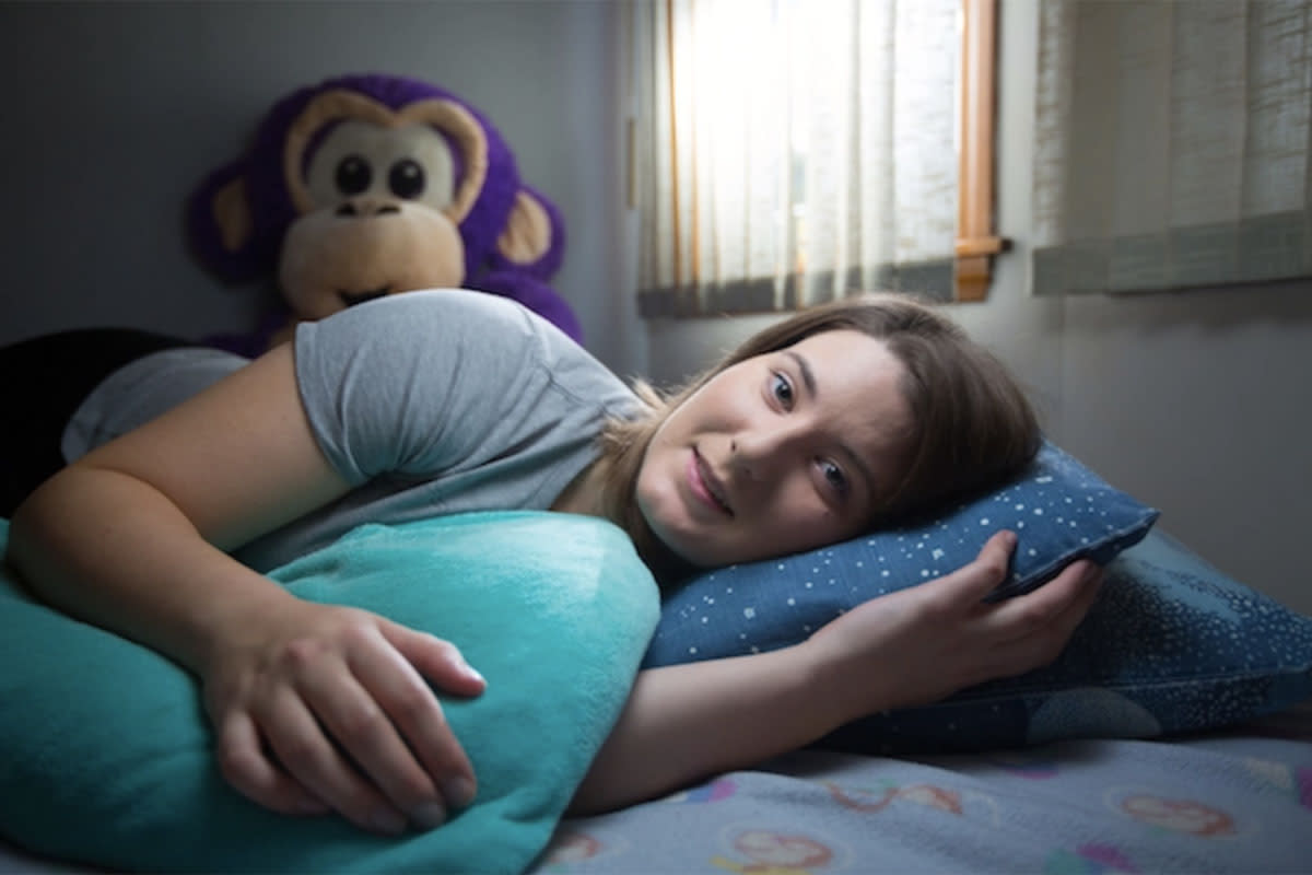 Professional snuggler Samantha Varnerin poses in her bedroom in Medford, Mass.