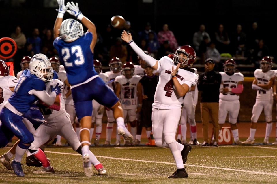 Santa Paula quarterback Marcus Castaneda fires a pass over a leaping Jarod Uridel of Fillmore during the teams' Citrus Coast League game at Fillmore High on Friday, Oct. 28, 2022. Fillmore won 35-28 to secure the outright league championship in the 112th meeting between the rival schools.