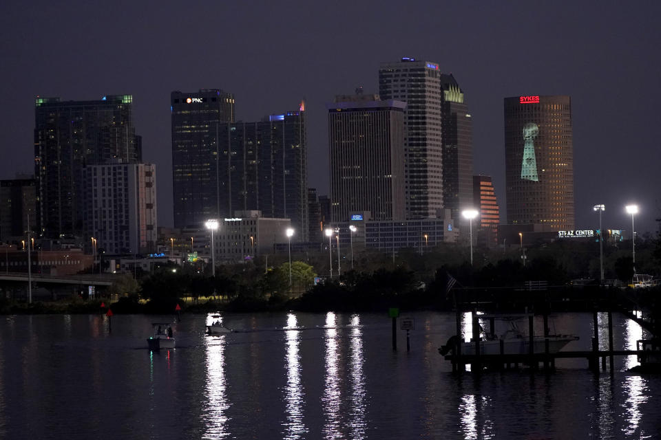 FILE - In this Feb. 4, 2021, file photo, signage for Super Bowl 55 is projected on a building in downtown Tampa, Fla. The city is hosting Sunday's Super Bowl NFL football game between the Tampa Bay Buccaneers and the Kansas City Chiefs. (AP Photo/Charlie Riedel, File)