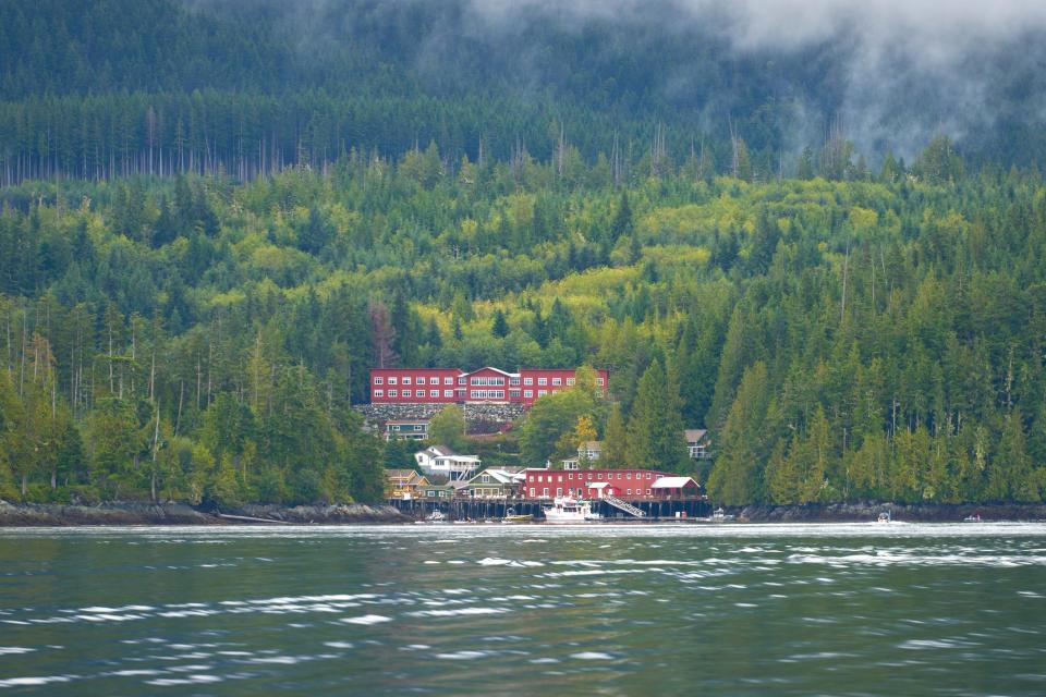 Views of trees surrounding red building in Johnstone Strait