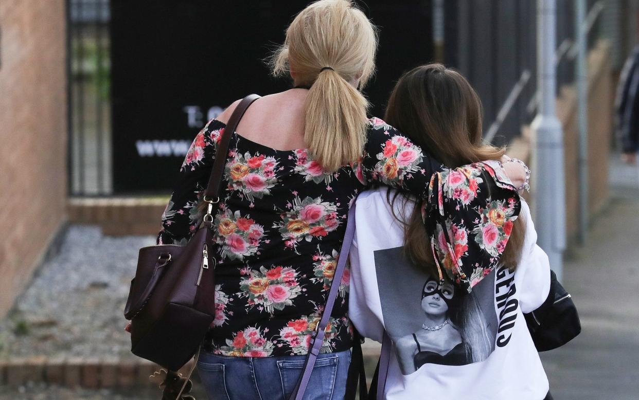 A mother and daughter leave the Park Inn, Manchester, where they were given refuge after the explosion at the Ariana Grande concert - Getty Images Europe