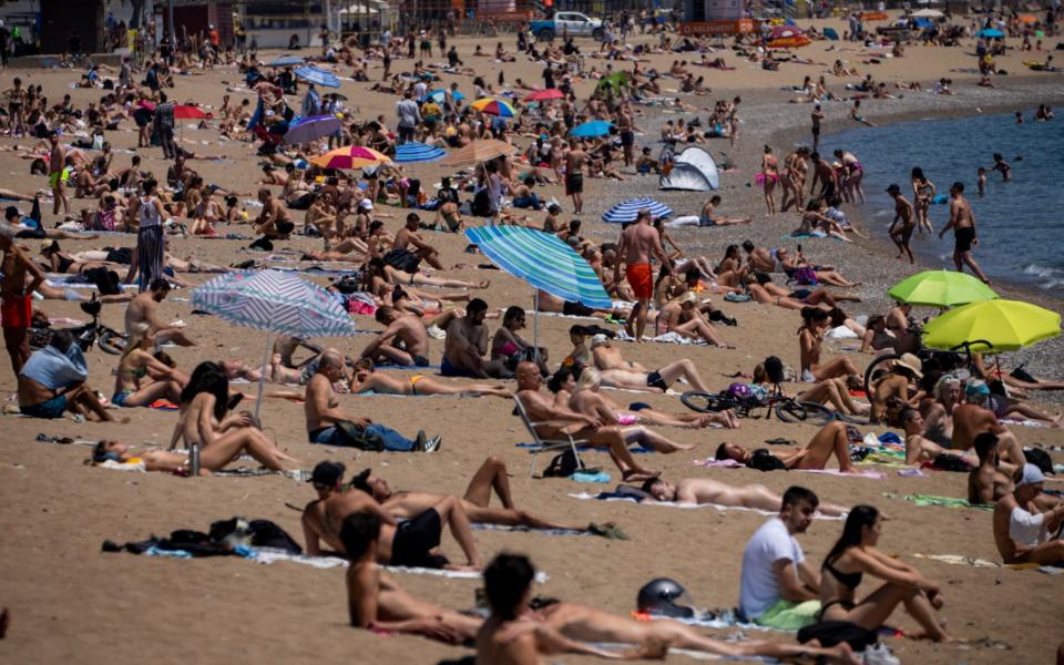 Meanwhile, the beach is much busier in Barcelona, Spain - AP