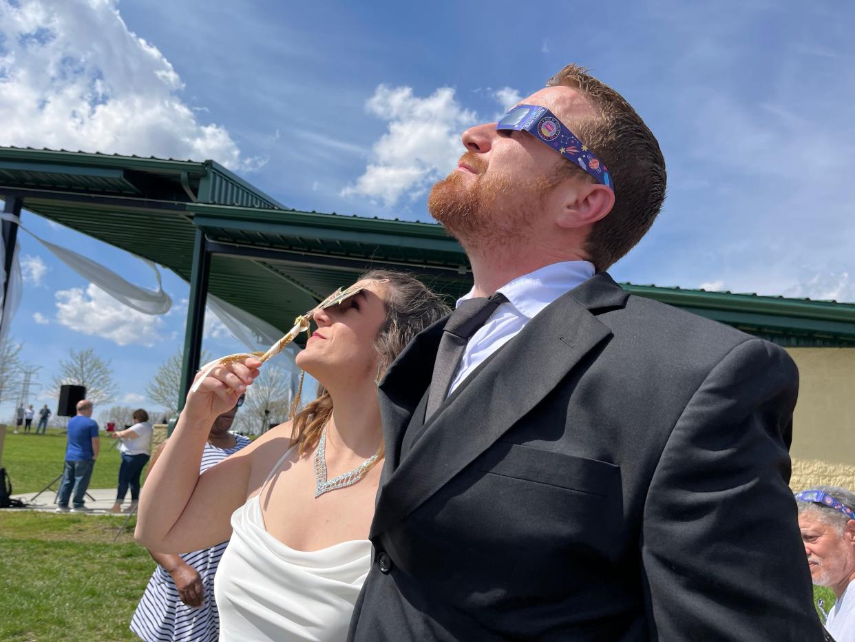 Local couple Samantha Palmer and Gerald Lester are minutes away from tying the knot at Trenton’s Solar Eclipse Mass Wedding Ceremony officiated by Mayor Ryan Perry. Trenton Community Park is bustling with families and dotted with brides and grooms.