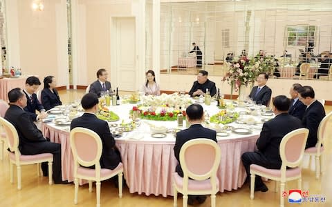 Members of the special delegation of South Korea's President with Kim Jong-un  - Credit: KCNA via Reuters