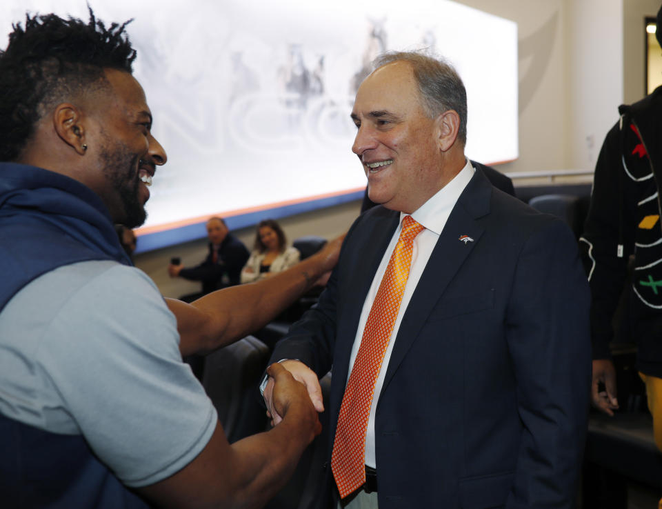 Denver Broncos new head coach Vic Fangio, right, greets wide receiver Emmanuel Sanders after a news conference at the team's headquarters Thursday, Jan. 10, 2019, in Englewood, Colo. (AP Photo/David Zalubowski)